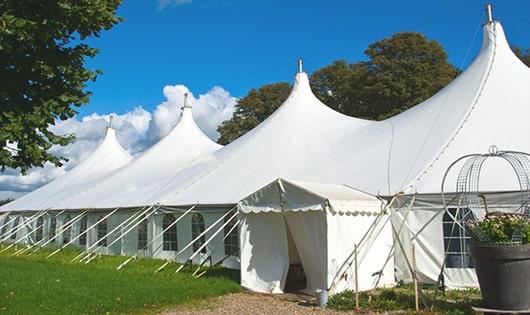 a line of portable restrooms in a shaded area, offering a comfortable experience for users in Mayodan